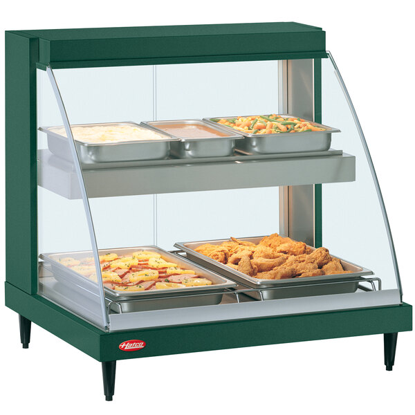 A green Hatco countertop food warmer display case with trays inside.