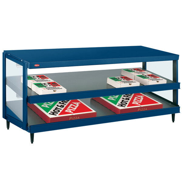 A blue shelf with boxes of pizza on it in a blue Hatco display case.