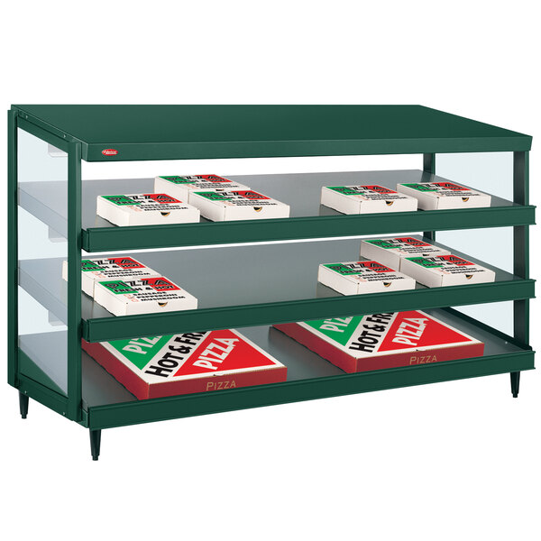 A Hatco Hunter Green countertop pizza warmer with pizza boxes on shelves.