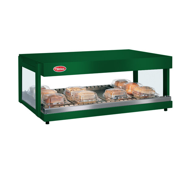 A Hunter Green Hatco countertop food warmer shelf with trays of food.