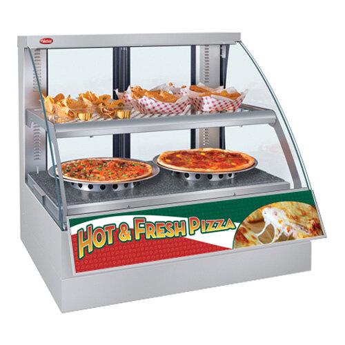 A Hatco Flav-R-Savor countertop display case with pizzas and other food on trays.