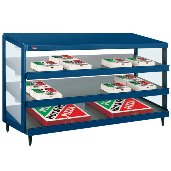 A blue Hatco countertop display shelf with boxes of pizza on it.