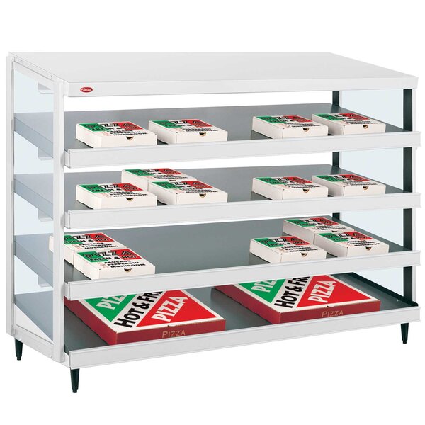 A white Hatco countertop shelf with pizza boxes on it.