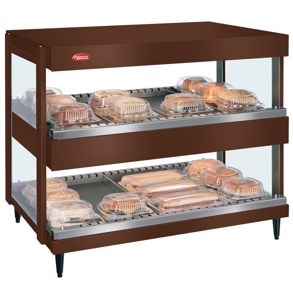 A Hatco countertop display warmer with trays of food on shelves.