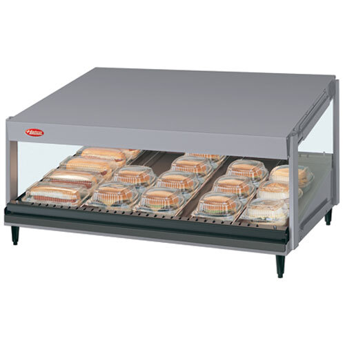 A Hatco countertop hot food display warmer with a slanted shelf holding trays of food.
