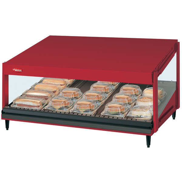 A red Hatco display case with food on a shelf.