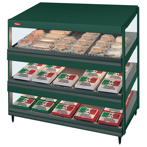 A Hunter green Hatco countertop display case with food on shelves.