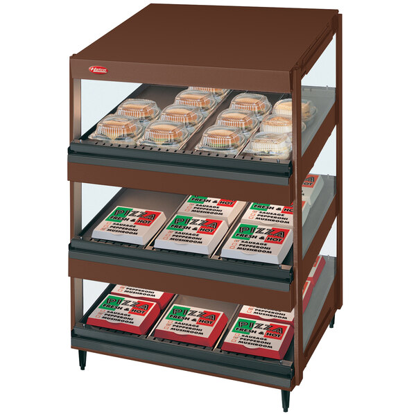 A brown and white Hatco countertop display case with food on slanted shelves.