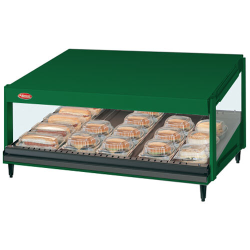 A green Hatco countertop display case with food on a slanted shelf.