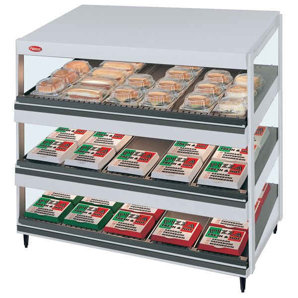 A Hatco Granite Glo-Ray slanted triple shelf countertop display case with food on it.