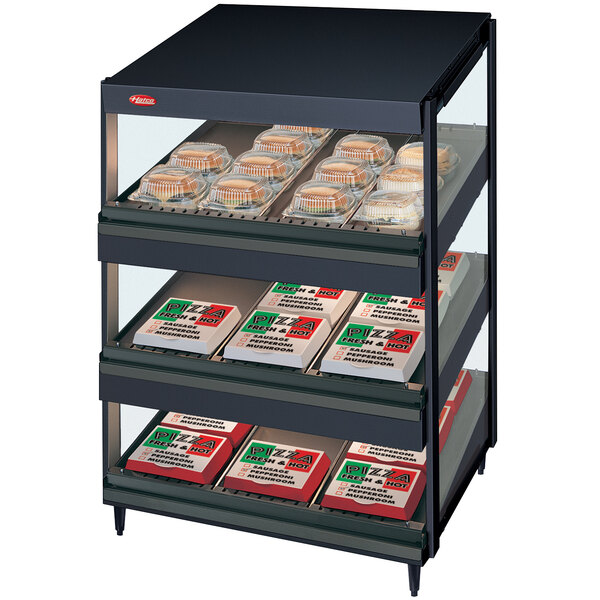 A black Hatco display case with slanted shelves holding trays of pizza.