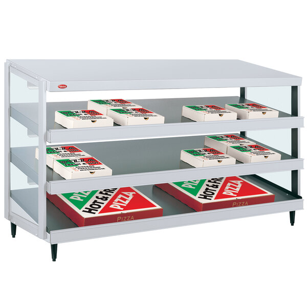 A Hatco Granite White pizza warmer shelf holding pizza boxes.