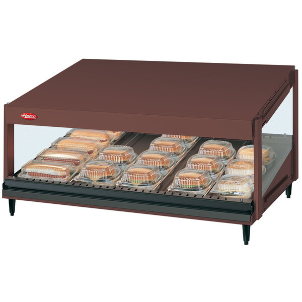 A Hatco countertop display case with trays of food inside.
