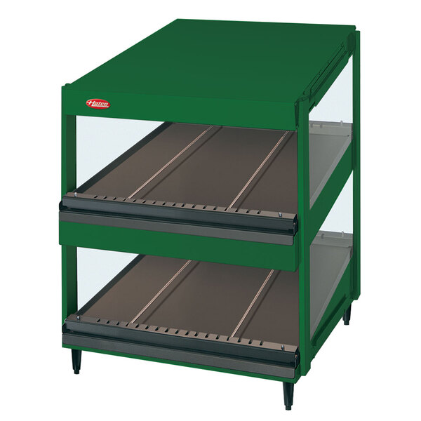 A green Hatco display case with slanted glass shelves.