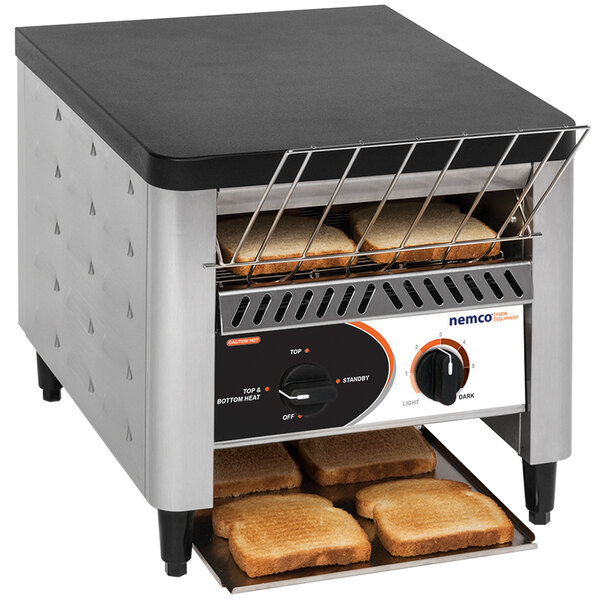 A Nemco conveyor toaster with four slices of toast on it.