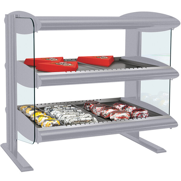 A Hatco countertop horizontal double shelf merchandiser with food on the shelves.