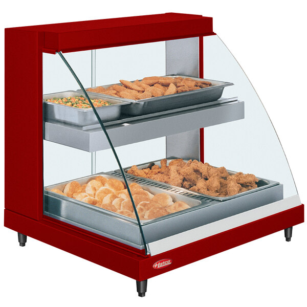 A red Hatco countertop food warmer display case with shelves full of food.