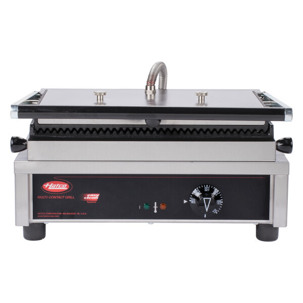 A Hatco panini grill with grooved plates on a counter.