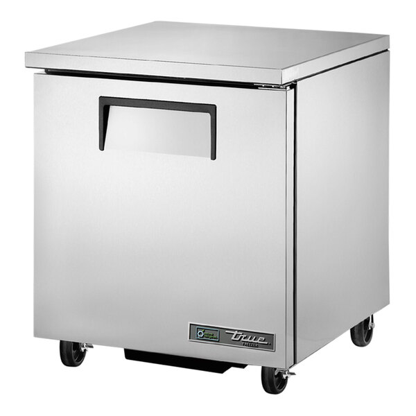 A stainless steel True undercounter freezer with wheels.