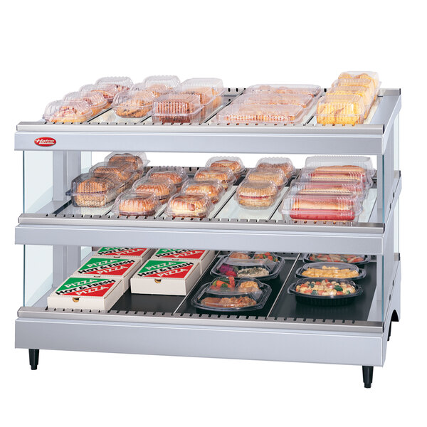 A Hatco Granite Glo-Ray heated double shelf food display case on a counter with food in it.