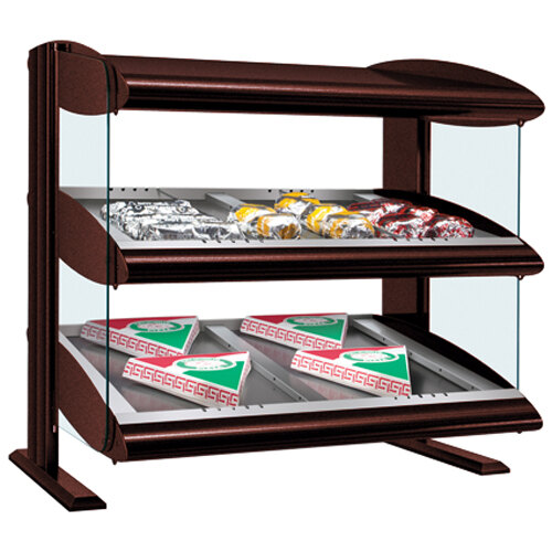 A Hatco slanted double shelf heated zone merchandiser displaying food on a counter.