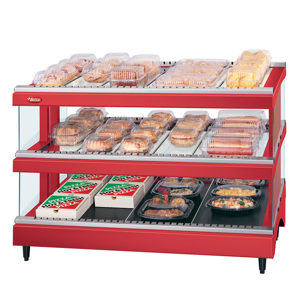 A red Hatco warm glass display case with food on shelves.
