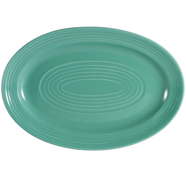 A green oval CAC China platter with a white oval pattern.