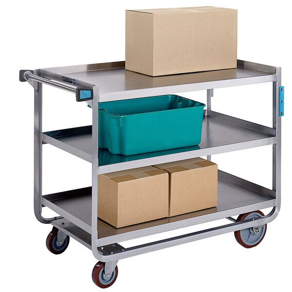 A Lakeside stainless steel utility cart with three tiers holding boxes.