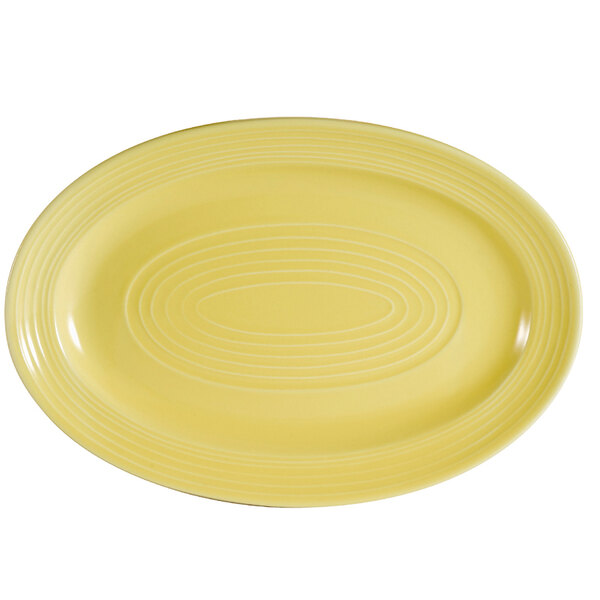 A yellow oval platter with a sunflower design in the center.