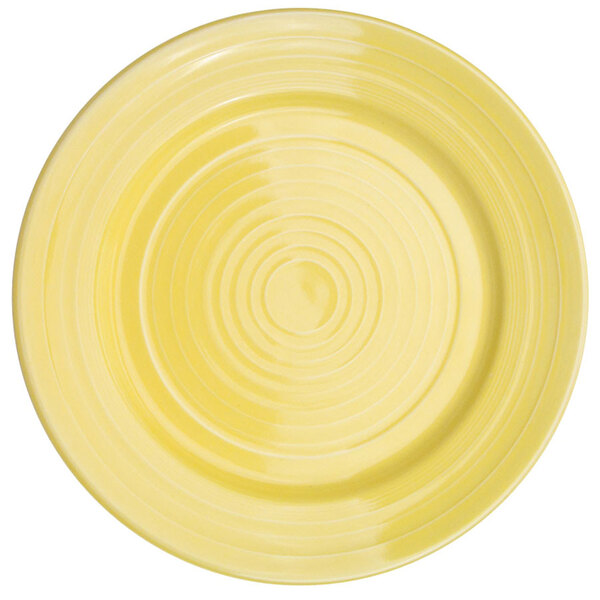 A yellow plate with a sunflower pattern in the center.