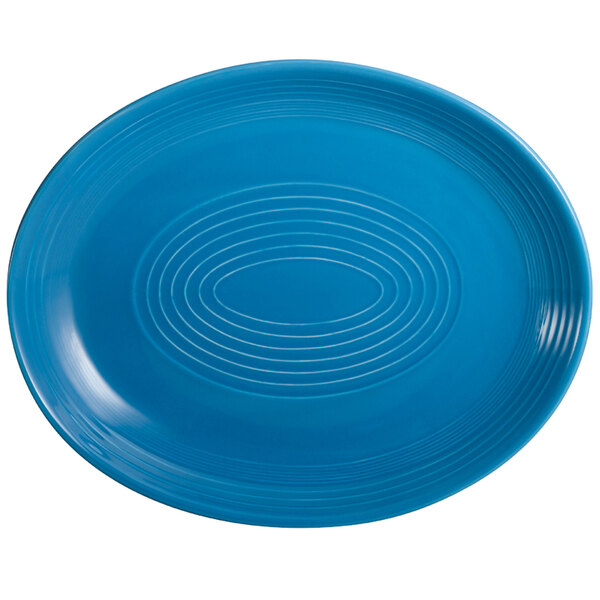 A peacock blue CAC china oval platter with a spiral pattern.
