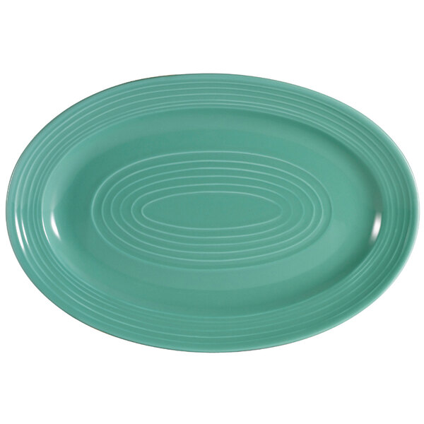 A green oval CAC China platter with a white patterned rim.