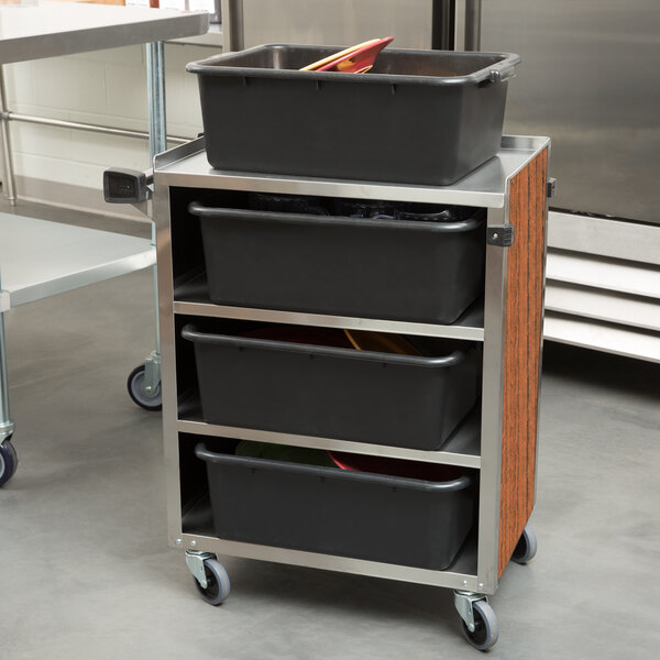 A Lakeside stainless steel utility cart with black containers on top.