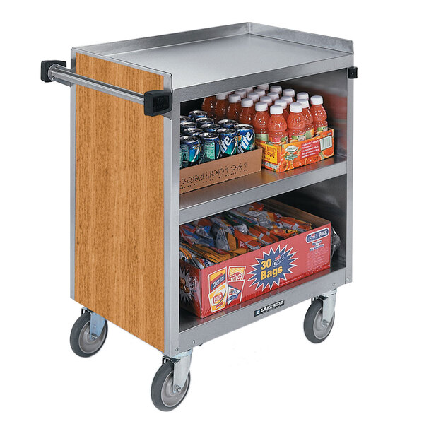 A Lakeside stainless steel utility cart with an enclosed base filled with drinks and snacks.