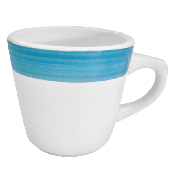 A close up of a white and blue CAC stoneware coffee cup with a stripe.