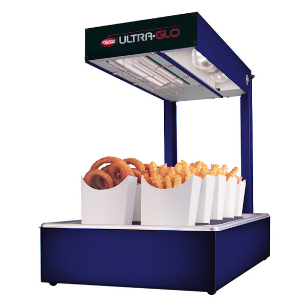 A Hatco Ultra-Glo portable food warmer with a variety of fries and onion rings.