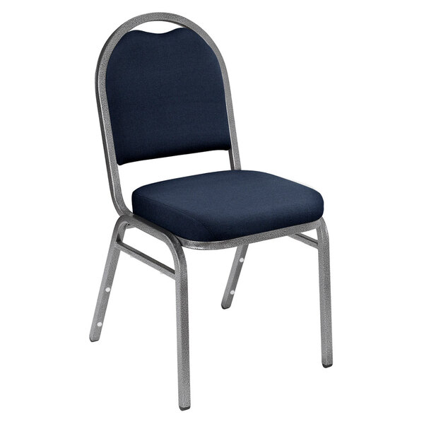 A National Public Seating silvervein stack chair with midnight blue fabric upholstery and a silver frame.