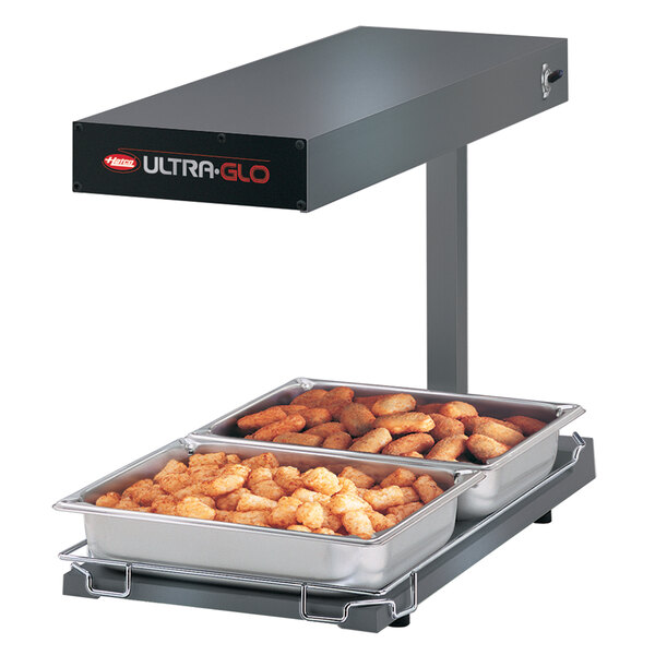 A Hatco Ultra-Glo food warmer with trays of food on a stand.