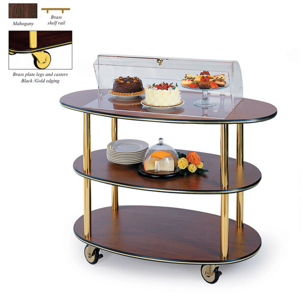 A Geneva mahogany serving cart with three tiers holding food under a glass cover.