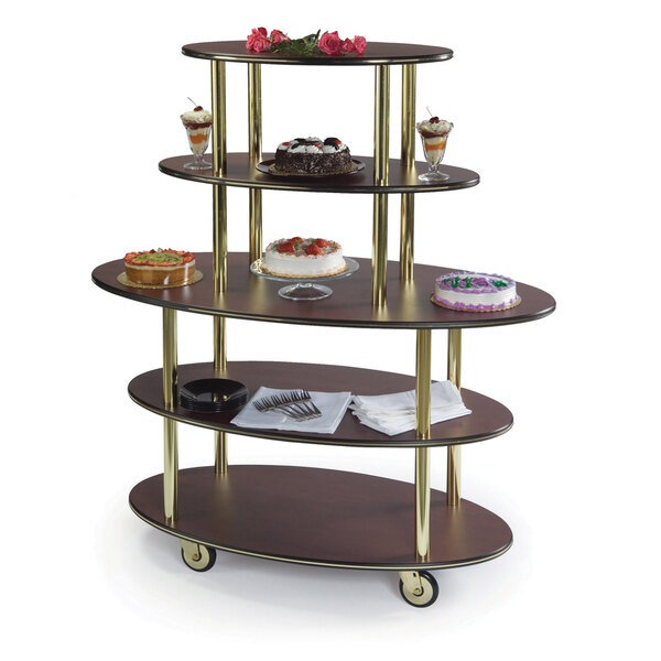A Geneva mahogany oval serving cart with three levels of desserts on it.