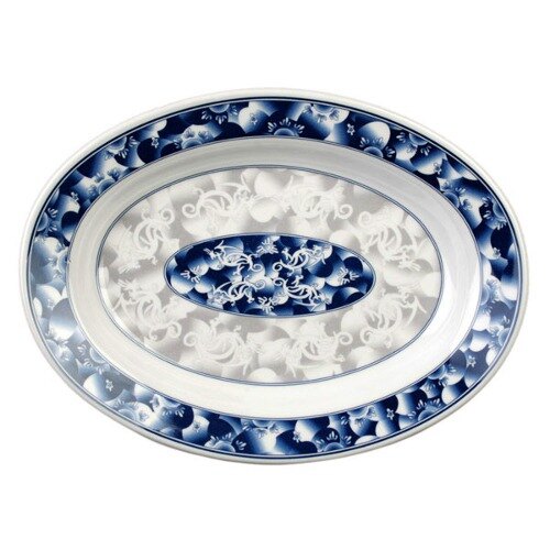 A blue and white oval melamine platter with a dragon design on it.