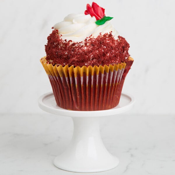An American Metalcraft Prestige porcelain serving stand with a cupcake with red velvet frosting and a rose on top.