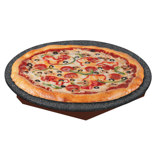 A pizza with pepperoni and olives on a Hatco heated stone shelf.