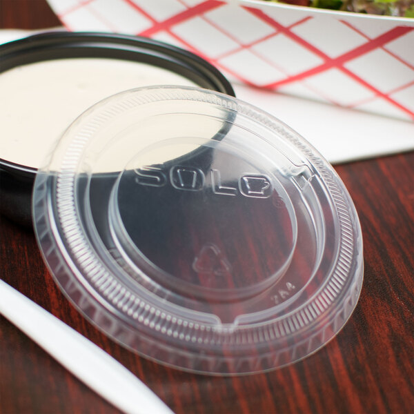 A Solo plastic lid on a container of food.