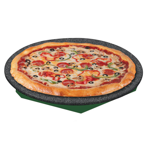 A pizza on a Hatco heated stone shelf with a green tray.