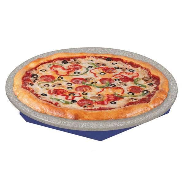 A pizza on a Hatco heated stone shelf with a blue tray on a table.