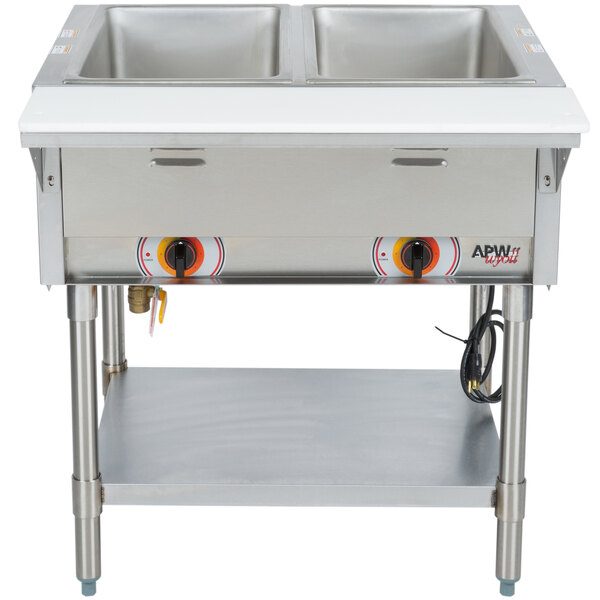 An APW Wyott stainless steel stationary steam table with two sealed wells on a counter.