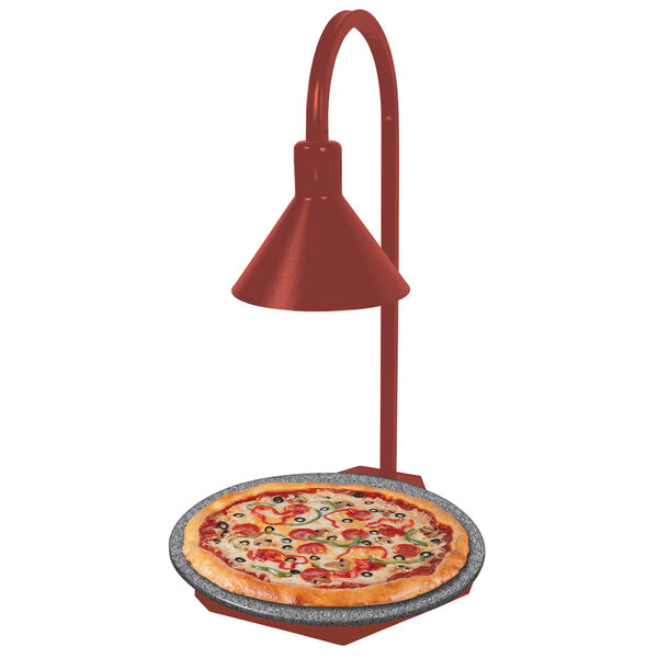 A Hatco heated stone shelf with a pizza on a plate being warmed under a red display lamp.