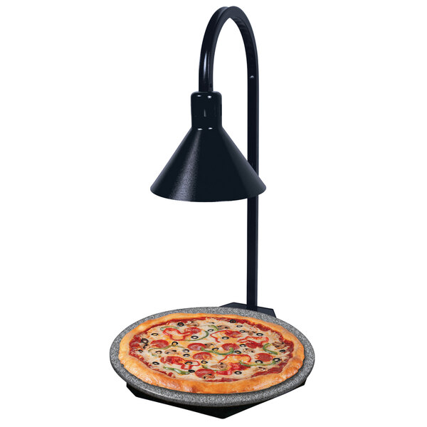 A pizza on a Hatco heated stone shelf with a display lamp over it.