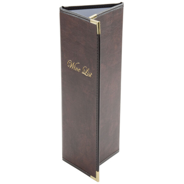 A brown leather Menu Solutions Royal Select Series menu cover with gold trim on a table in a winery cellar.